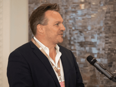 A founder speaking at a microphone