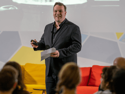 Benjamin presenting to a seated audience